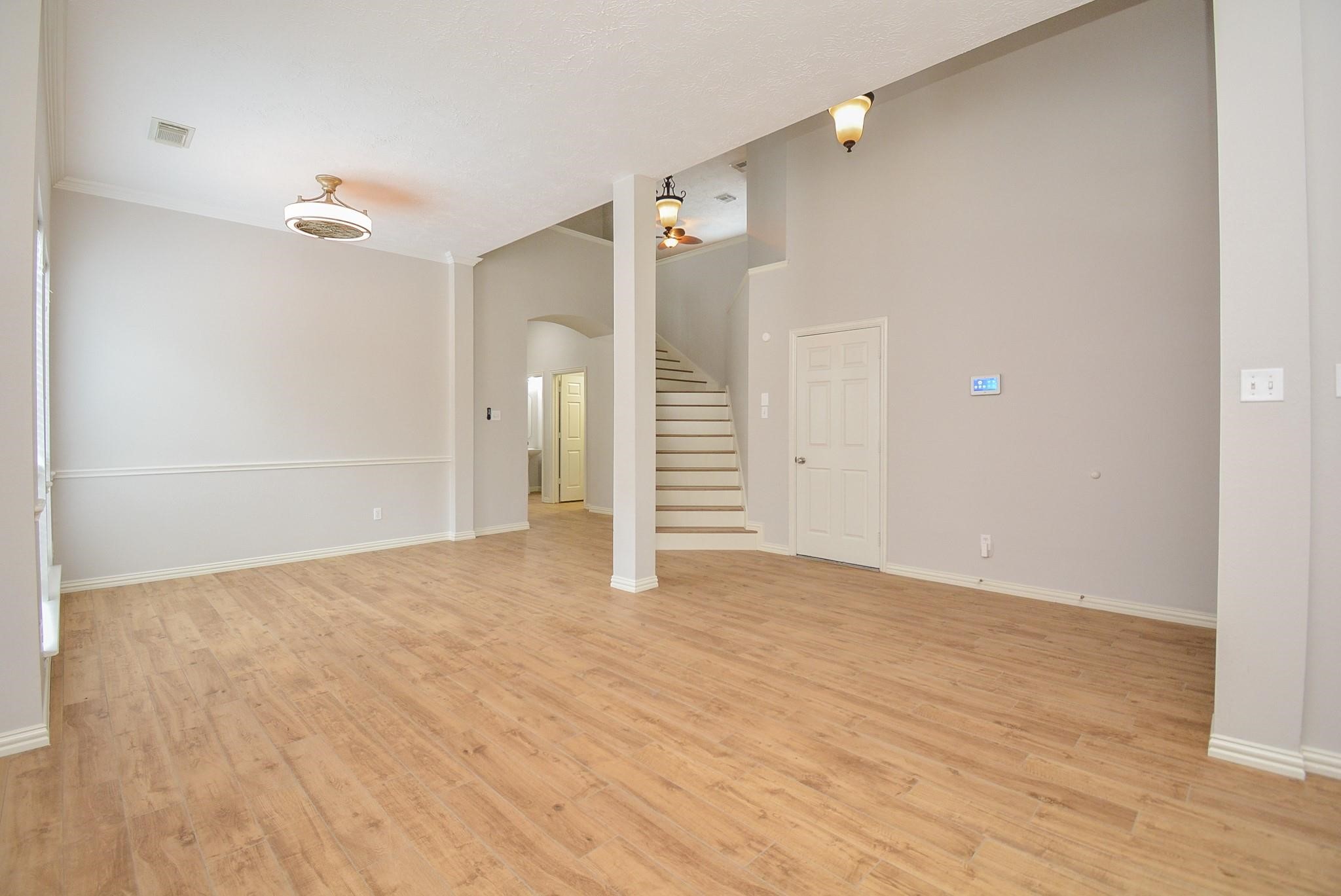 4007 Gazebo Lane Missouri City, TX 77459 - Photo 4 of 21 wooden floor in an empty room with a window