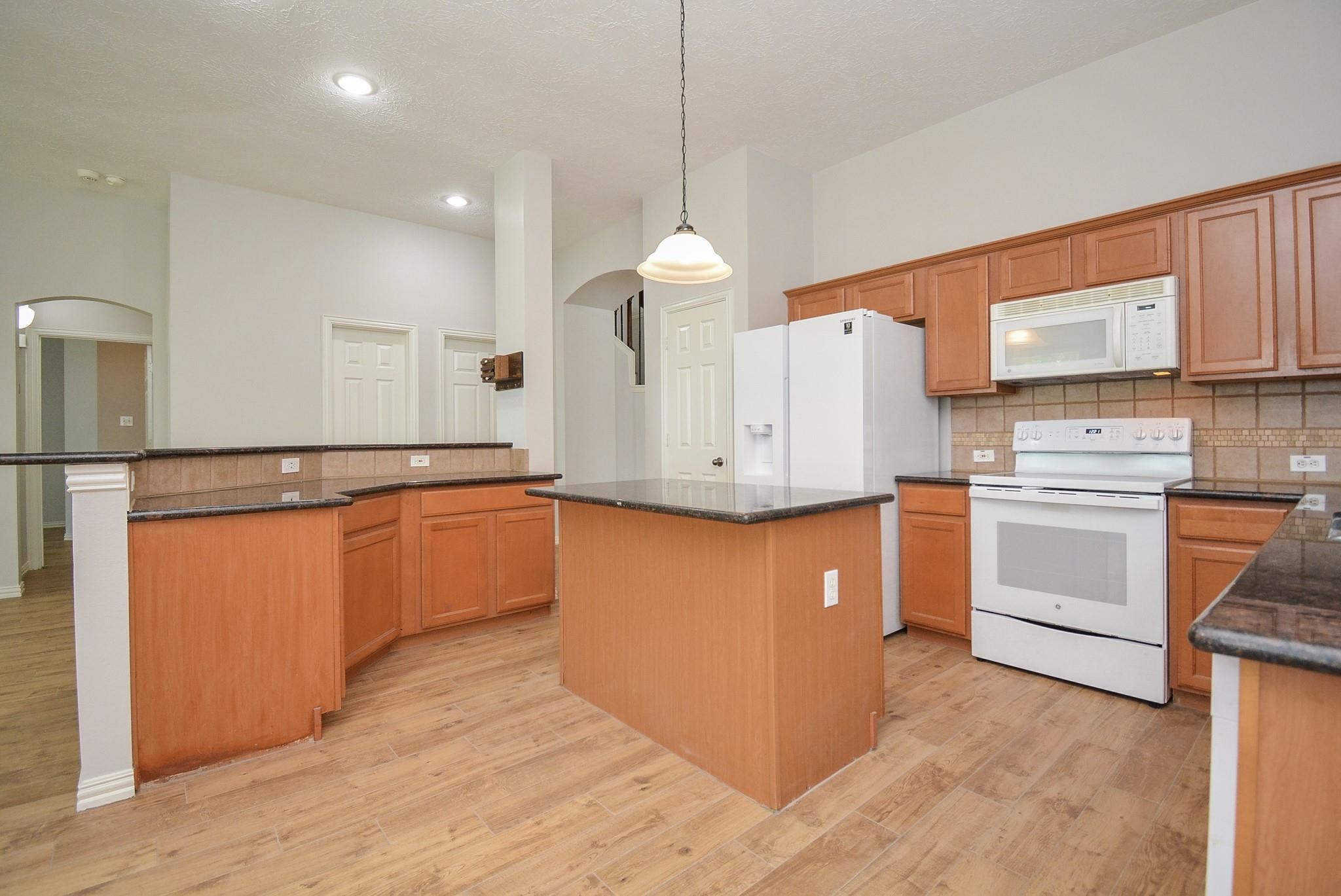 4007 Gazebo Lane Missouri City, TX 77459 - Photo 8 of 21 a kitchen with granite countertop white cabinets and white appliances