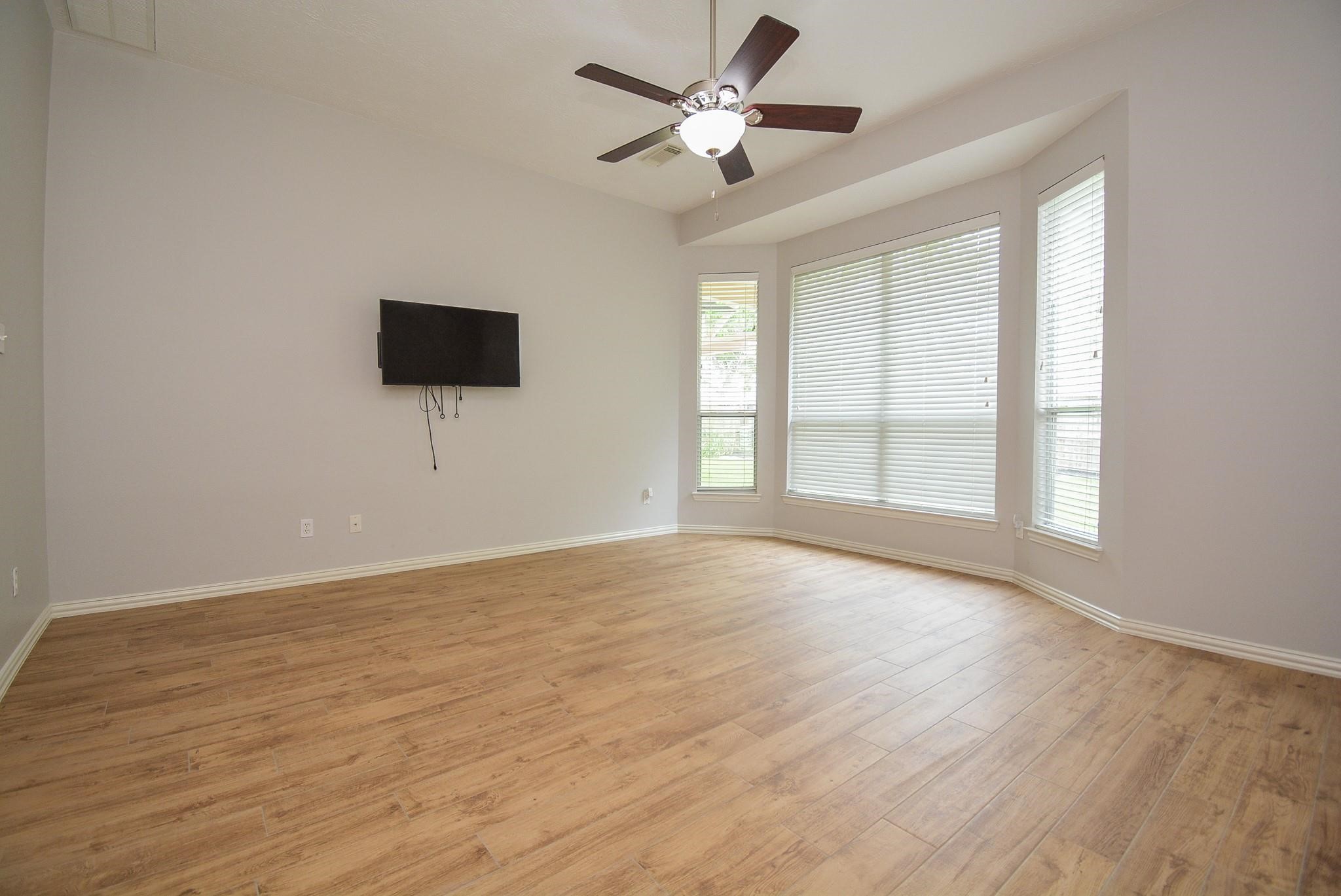 4007 Gazebo Lane Missouri City, TX 77459 - Photo 10 of 21 a view of an empty room with a window and a flat screen tv