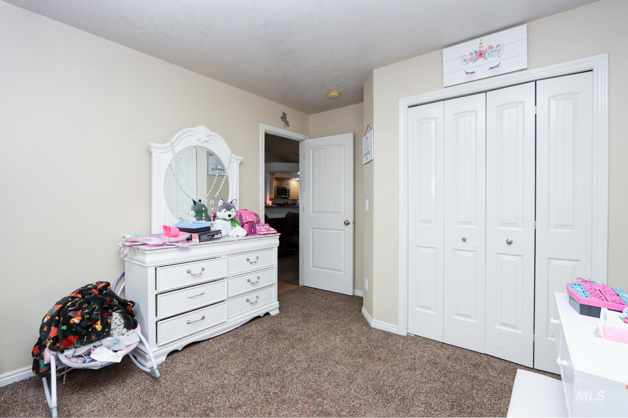 1010 North Rodeo Street Parma, ID 83660 - Photo 12 of 19 Carpeted bedroom featuring a closet and baseboards