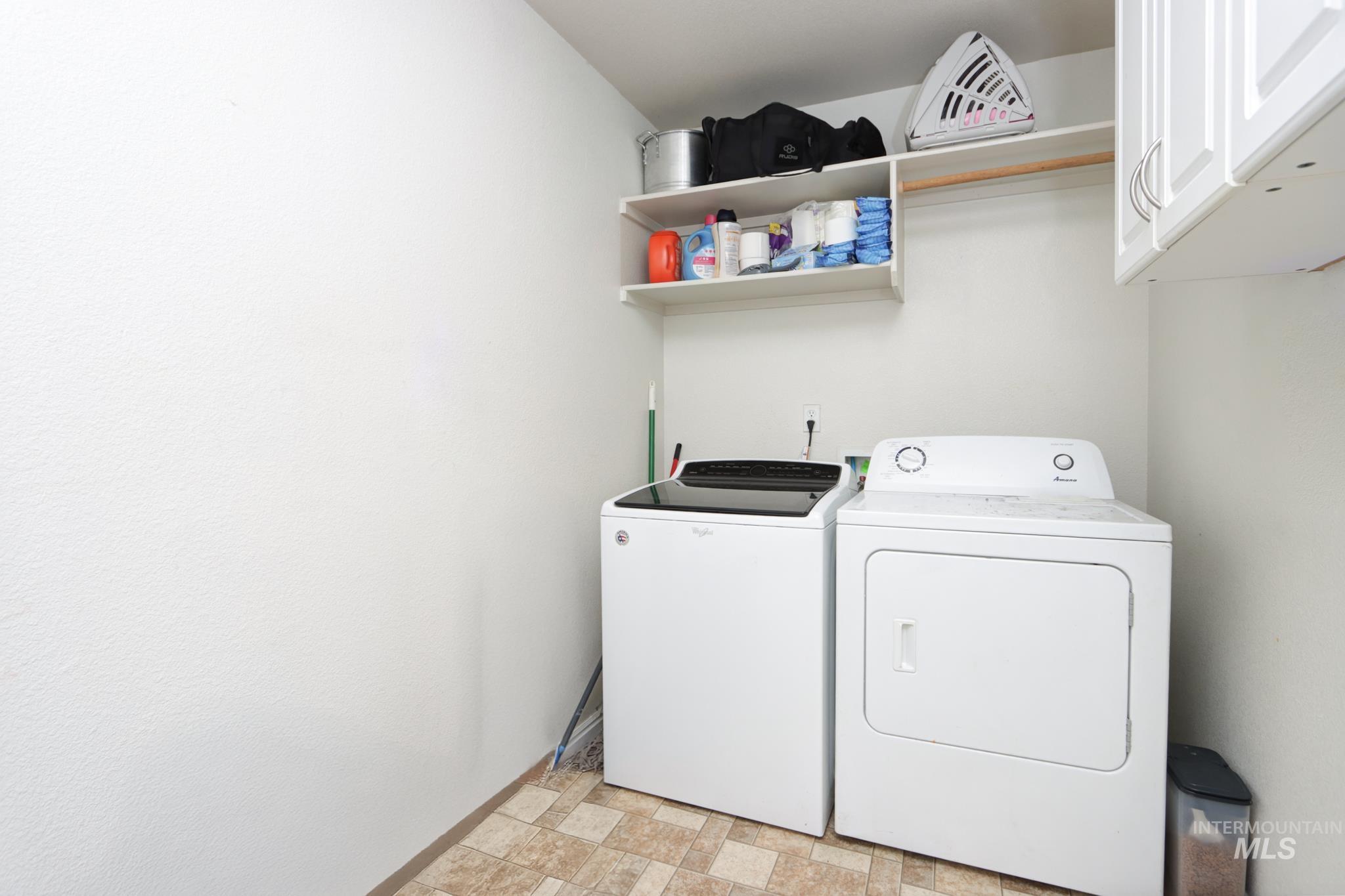 1010 North Rodeo Street Parma, ID 83660 - Photo 15 of 19 Laundry room featuring cabinet space, washer and clothes dryer, and light flooring