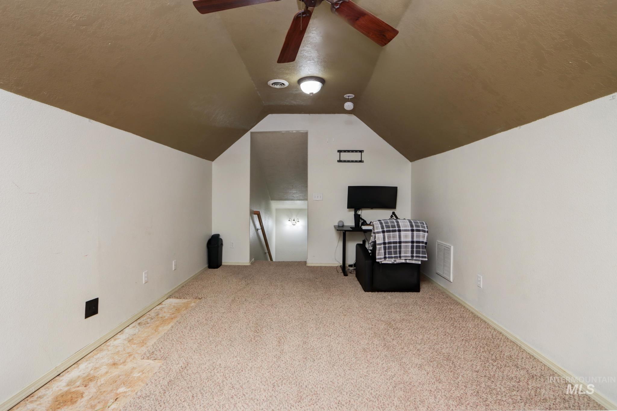 1010 North Rodeo Street Parma, ID 83660 - Photo 16 of 19 Bonus room featuring vaulted ceiling and carpet floors