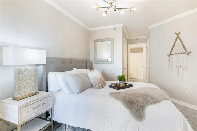 a bedroom with a bed and a chandelier