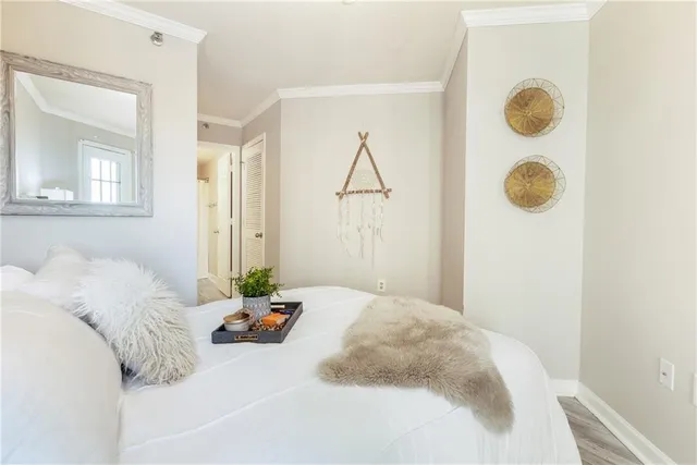 a bed sitting in a bedroom next to a window