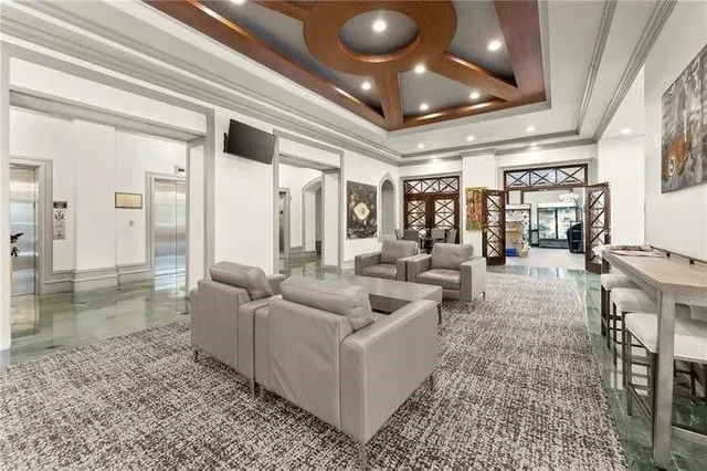 a view of a swimming pool with lawn chairs and potted plants