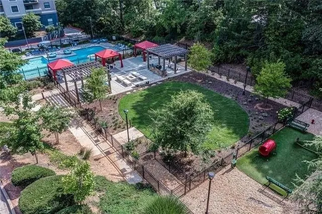 a swimming pool with outdoor seating and yard