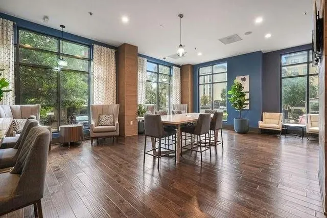 a view of a room with gym equipment and large window