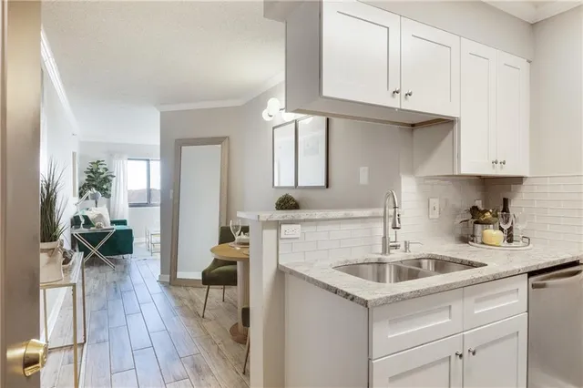 a kitchen with a sink cabinets and wooden floor