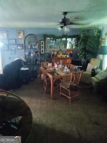 a dining room with furniture and a large window