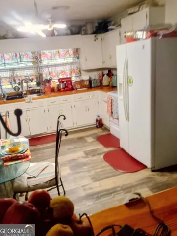 a room with lots of appliances and cabinets