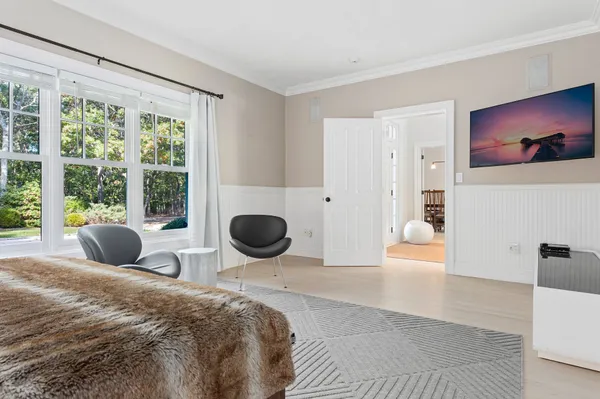 a bedroom with a bed and a large window