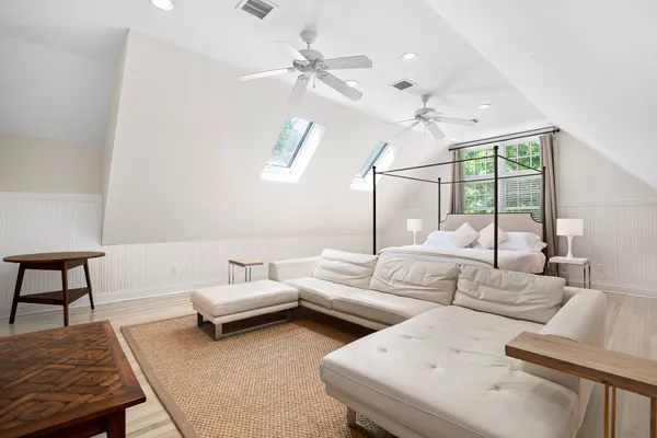 a living room with furniture a chandelier and a window