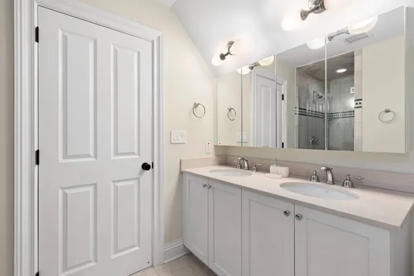 a bathroom with a double vanity sink and a mirror