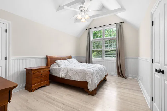 a bedroom with a large bed and a window