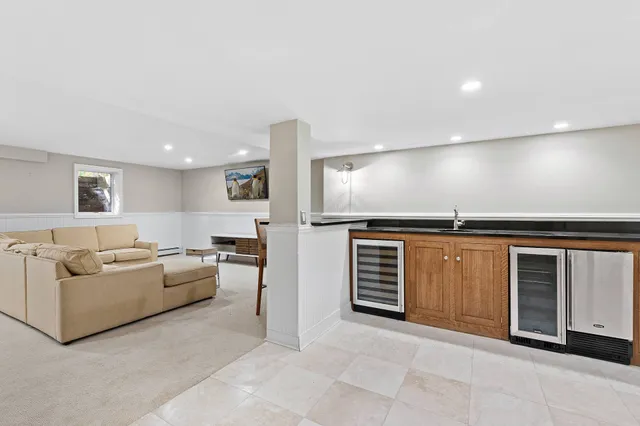 a living room with furniture and kitchen