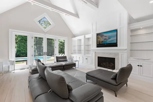 a living room with furniture large window and a fireplace