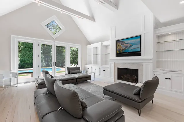 a living room with furniture large window and a fireplace