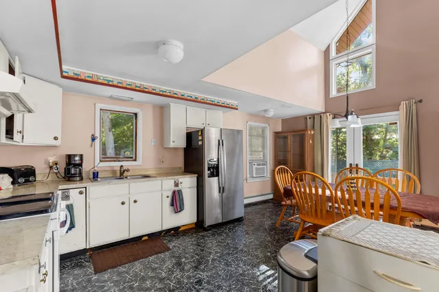 a kitchen with a sink appliances and furniture