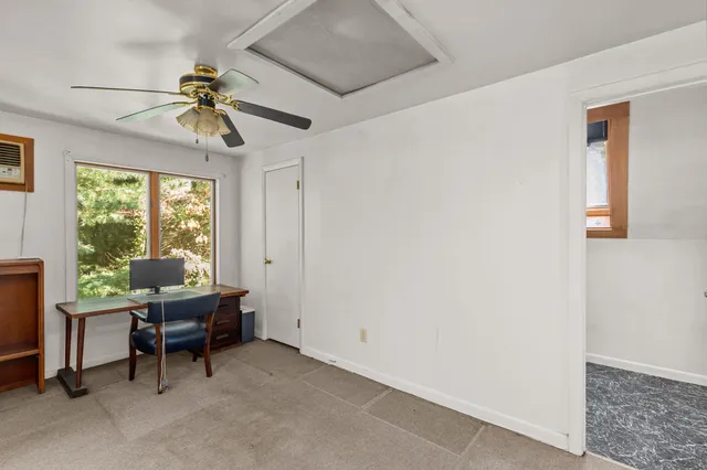 a workspace with wooden floor and windows