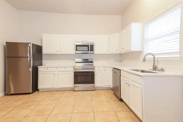 a kitchen with a sink a stove and refrigerator