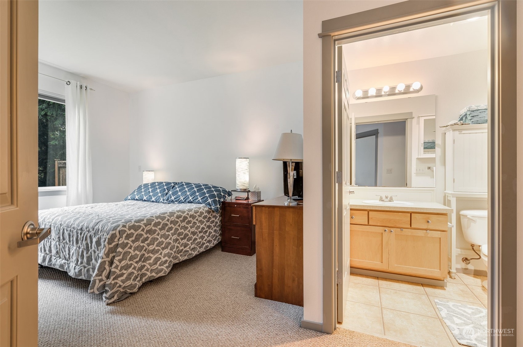 2009 196th Street Southeast, Unit F102 Bothell, WA 98012 - Photo 14 of 18 a bedroom with a bed and a mirror