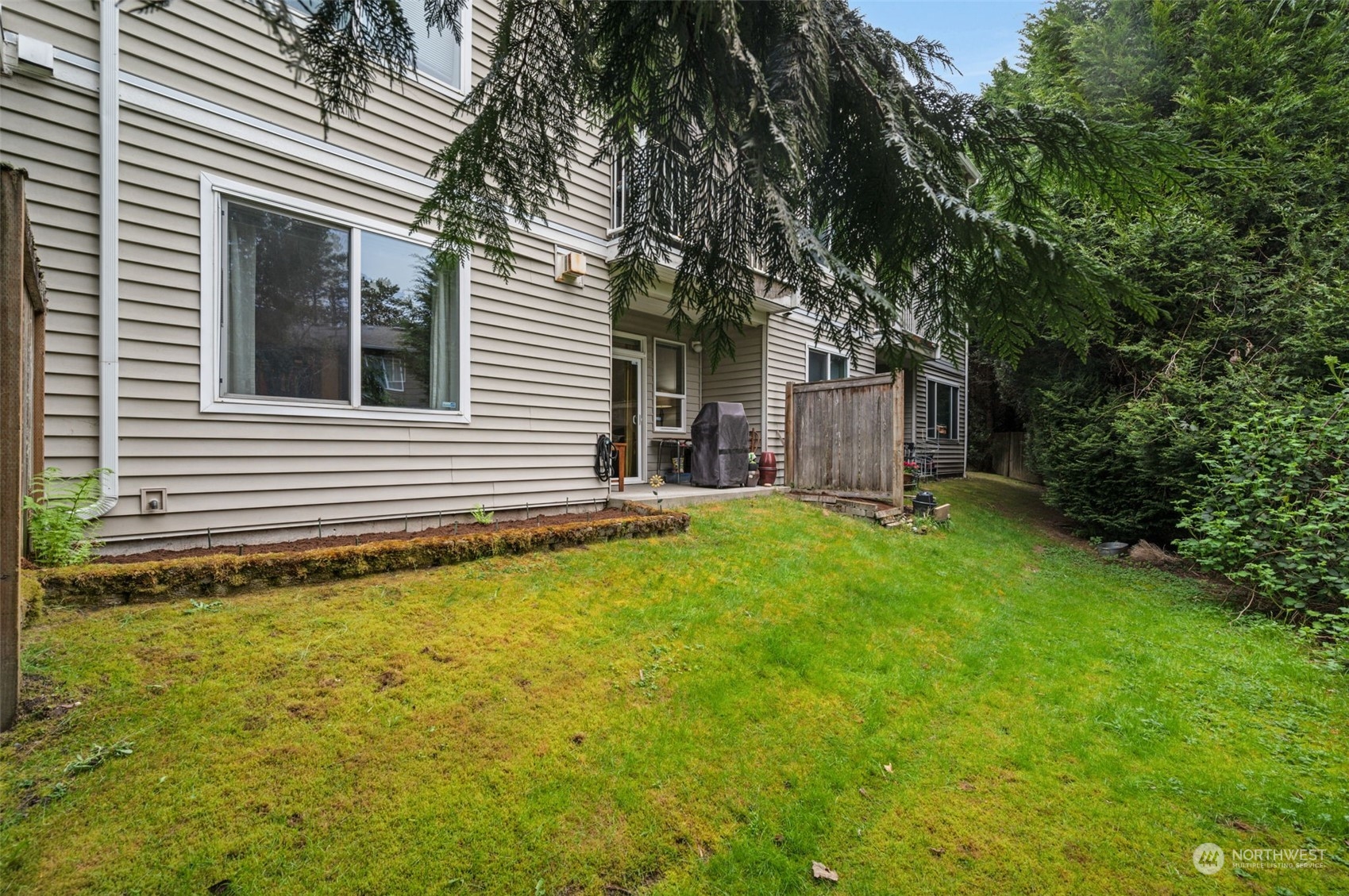 2009 196th Street Southeast, Unit F102 Bothell, WA 98012 - Photo 18 of 18 a view of a house with a yard and tree