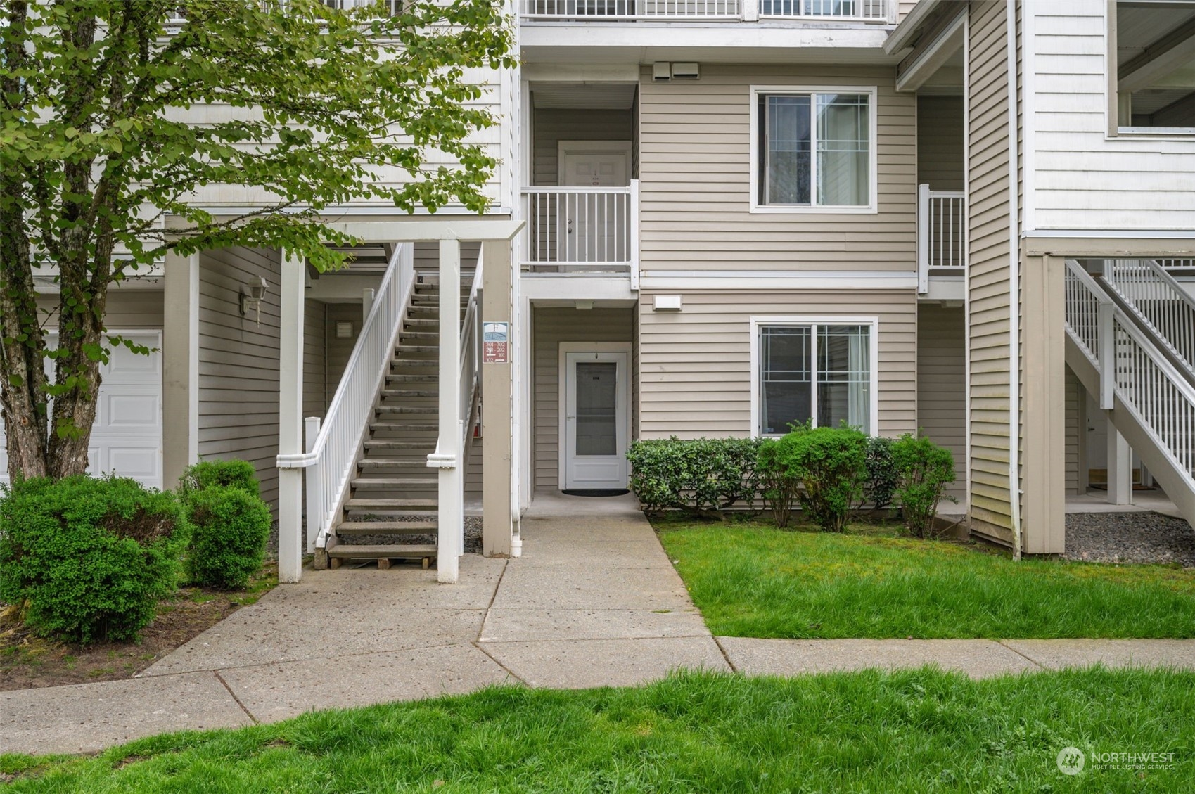 2009 196th Street Southeast, Unit F102 Bothell, WA 98012 - Photo 3 of 18 a front view of a house with a yard