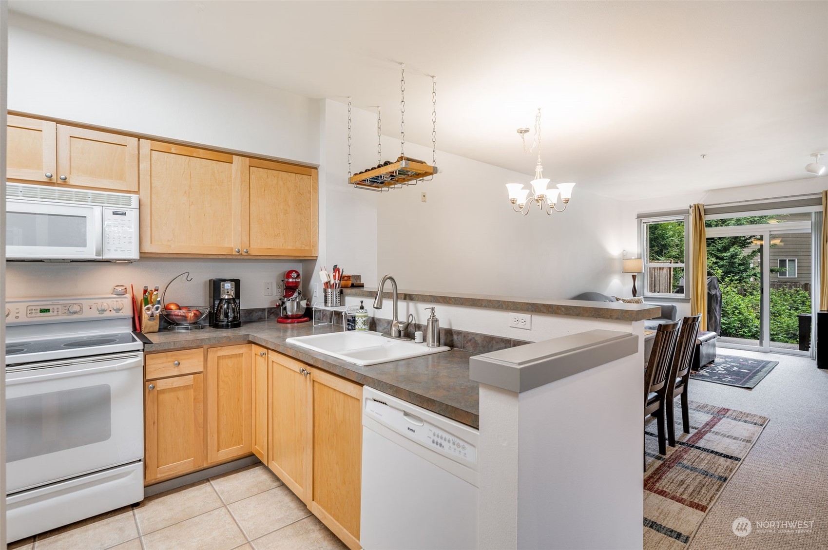 2009 196th Street Southeast, Unit F102 Bothell, WA 98012 - Photo 9 of 18 a kitchen with a sink stove and white cabinets