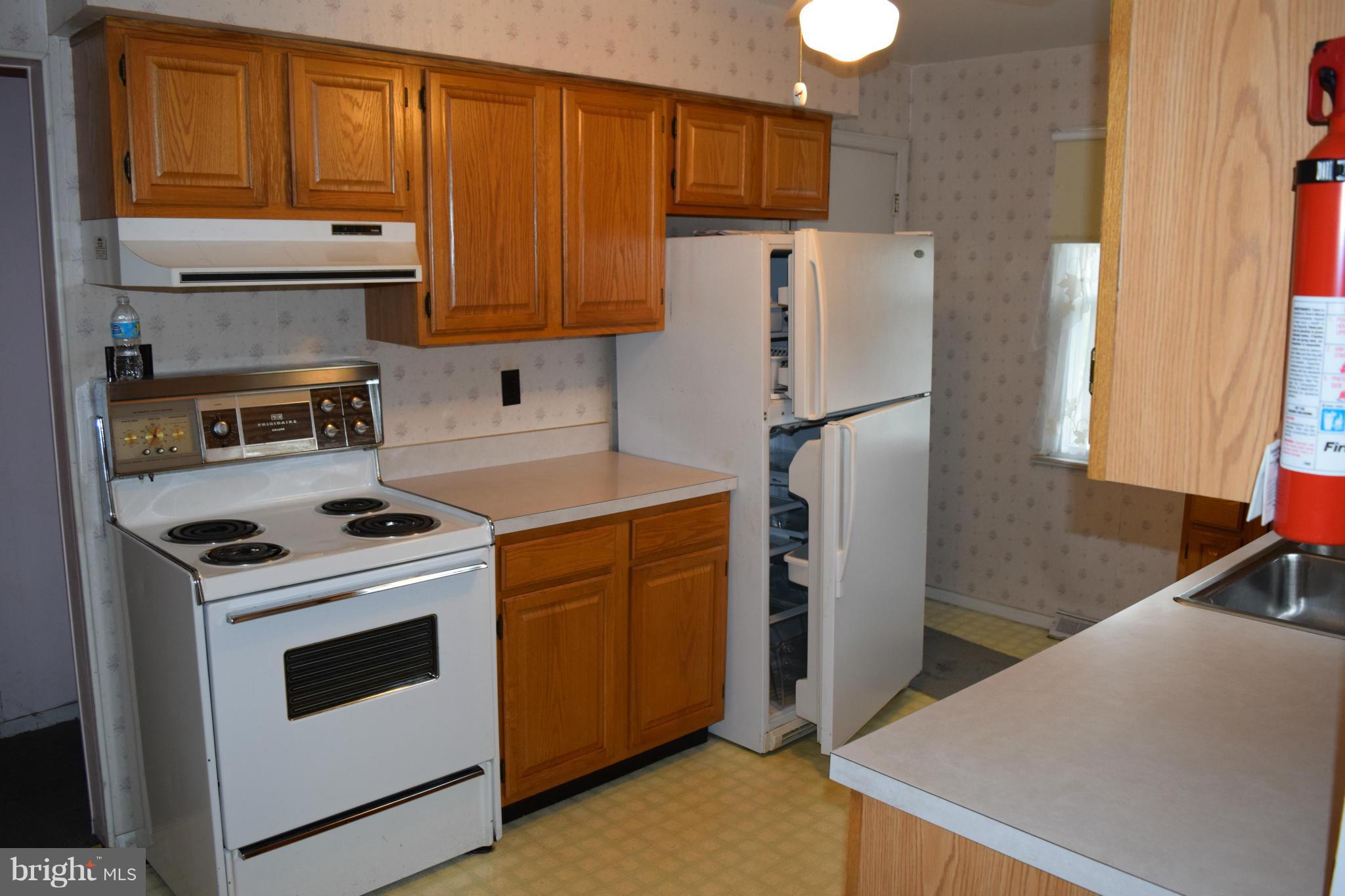 301 Nottingham Road Hagerstown, MD 21740 - Photo 3 of 11 a kitchen with a white stove top oven and refrigerator