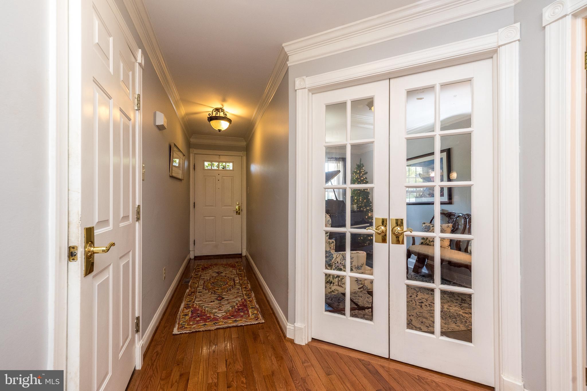 329 Manor Road Harleysville, PA 19438 - Photo 19 of 39 a view of a hallway with wooden floor and windows
