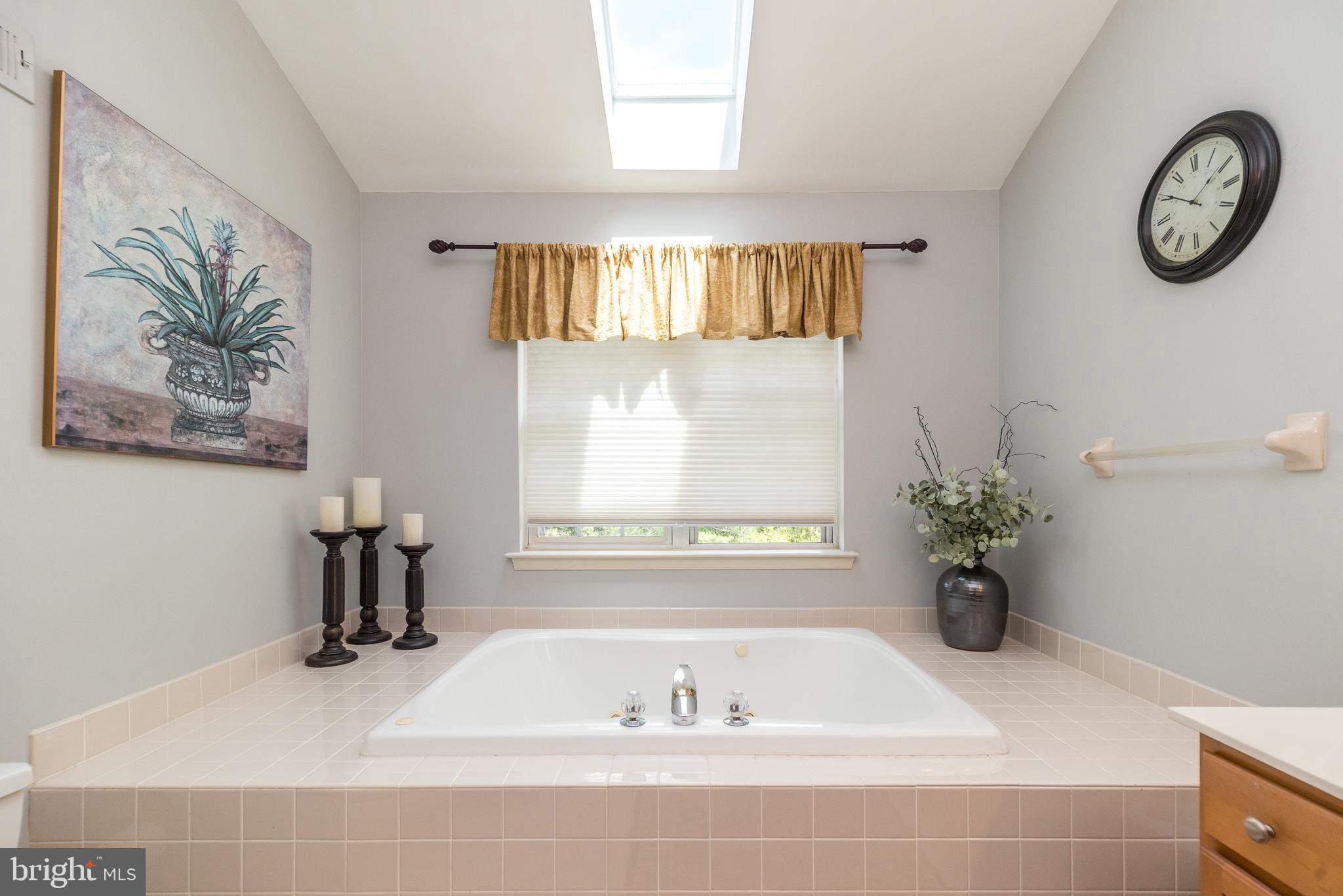 329 Manor Road Harleysville, PA 19438 - Photo 26 of 39 a bathroom with a tub and a window
