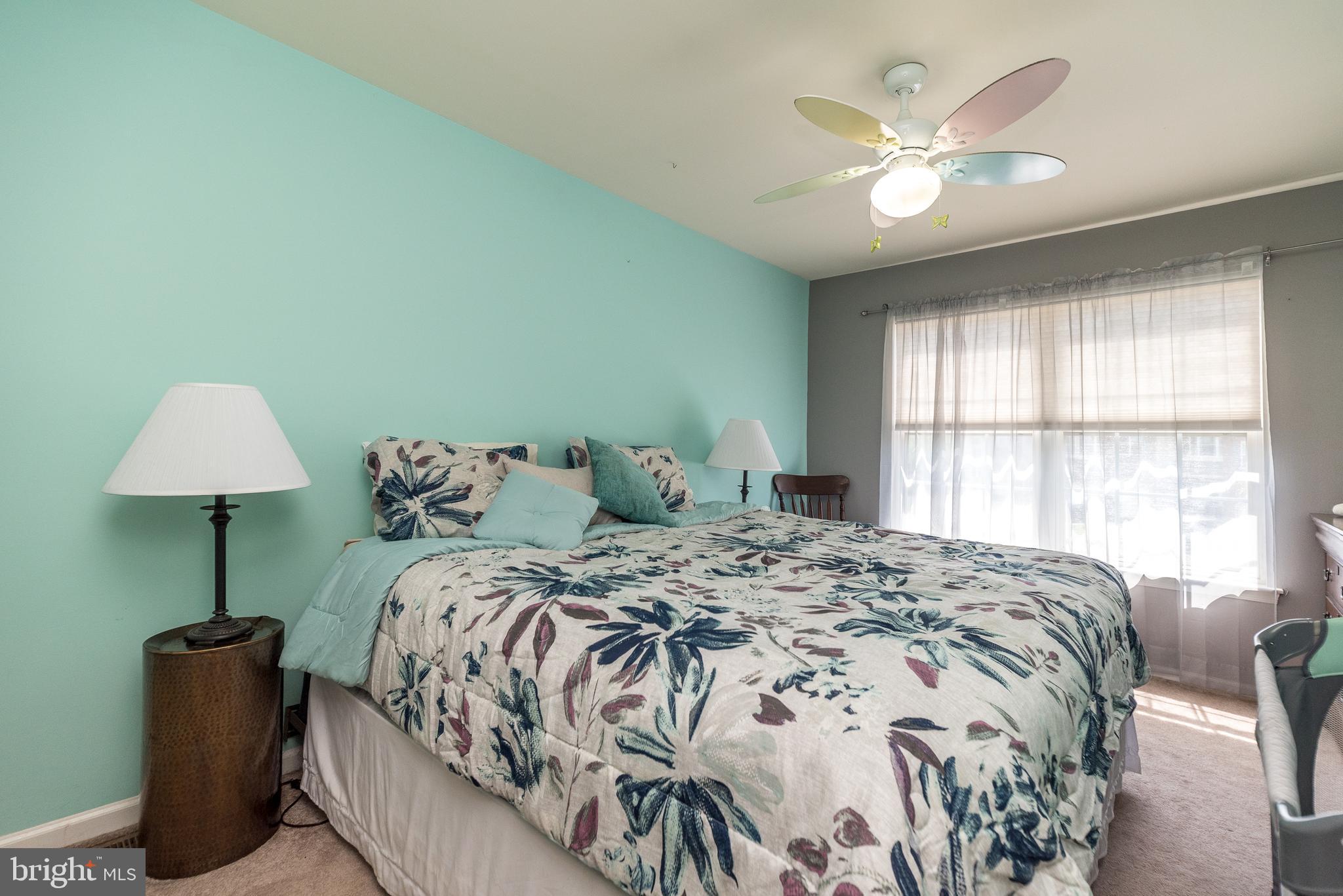329 Manor Road Harleysville, PA 19438 - Photo 28 of 39 a bedroom with a bed and a chandelier