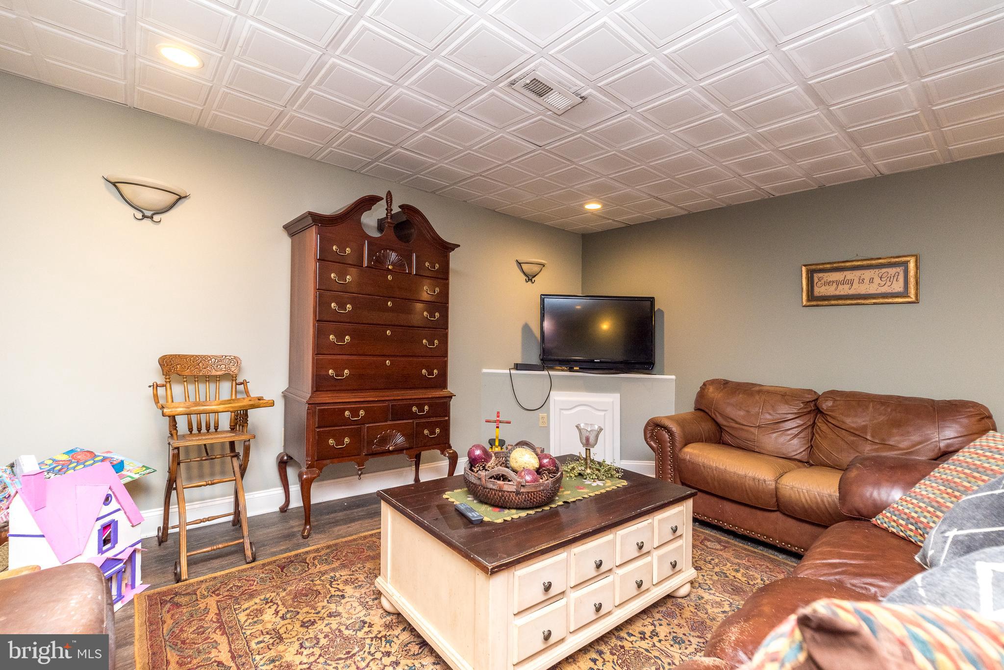 329 Manor Road Harleysville, PA 19438 - Photo 32 of 39 a living room with furniture and a flat screen tv