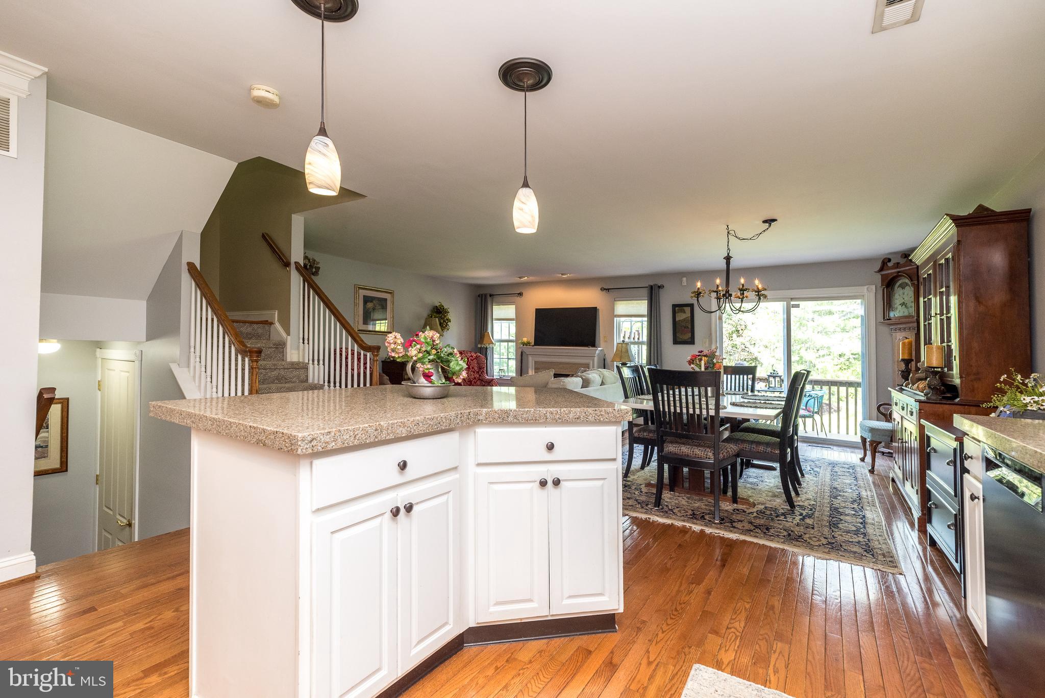 329 Manor Road Harleysville, PA 19438 - Photo 7 of 39 a kitchen with stainless steel appliances granite countertop wooden floors and white cabinets