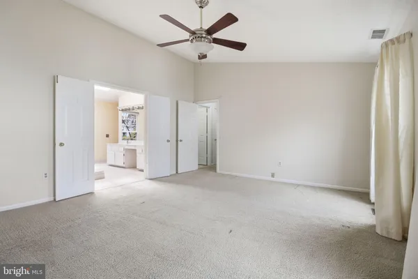 a spacious bathroom with a tub sink and mirror