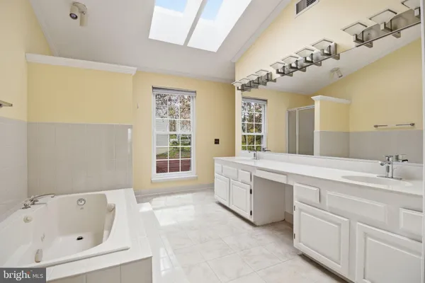 a bathroom with a tub shower and sink