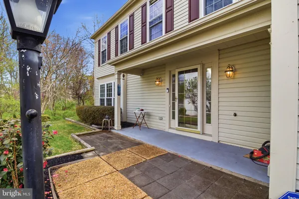 a backyard of a house with barbeque oven and outdoor seating