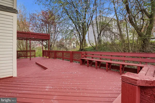 a view of backyard with deck and wooden floor