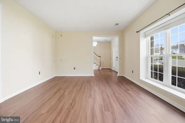 a view of a room with wooden floor and window