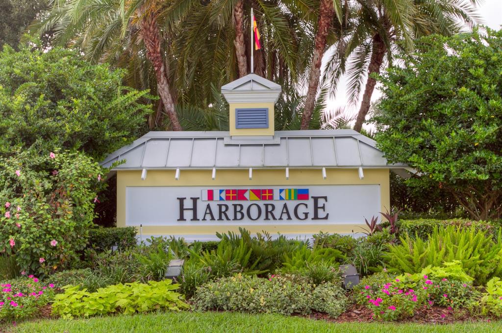 5511 Key W Place, Unit 5511 Bradenton, FL 34203 - Photo 22 of 38 a sign that is sitting in front of a house with large trees