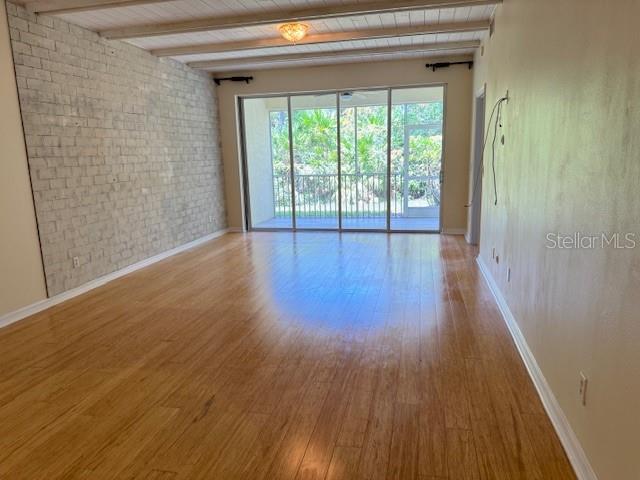 5511 Key W Place, Unit 5511 Bradenton, FL 34203 - Photo 4 of 38 a view of empty room with wooden floor and fan