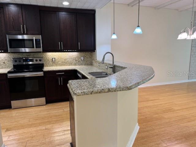 5511 Key W Place, Unit 5511 Bradenton, FL 34203 - Photo 8 of 38 a kitchen with stainless steel appliances granite countertop a sink and a microwave