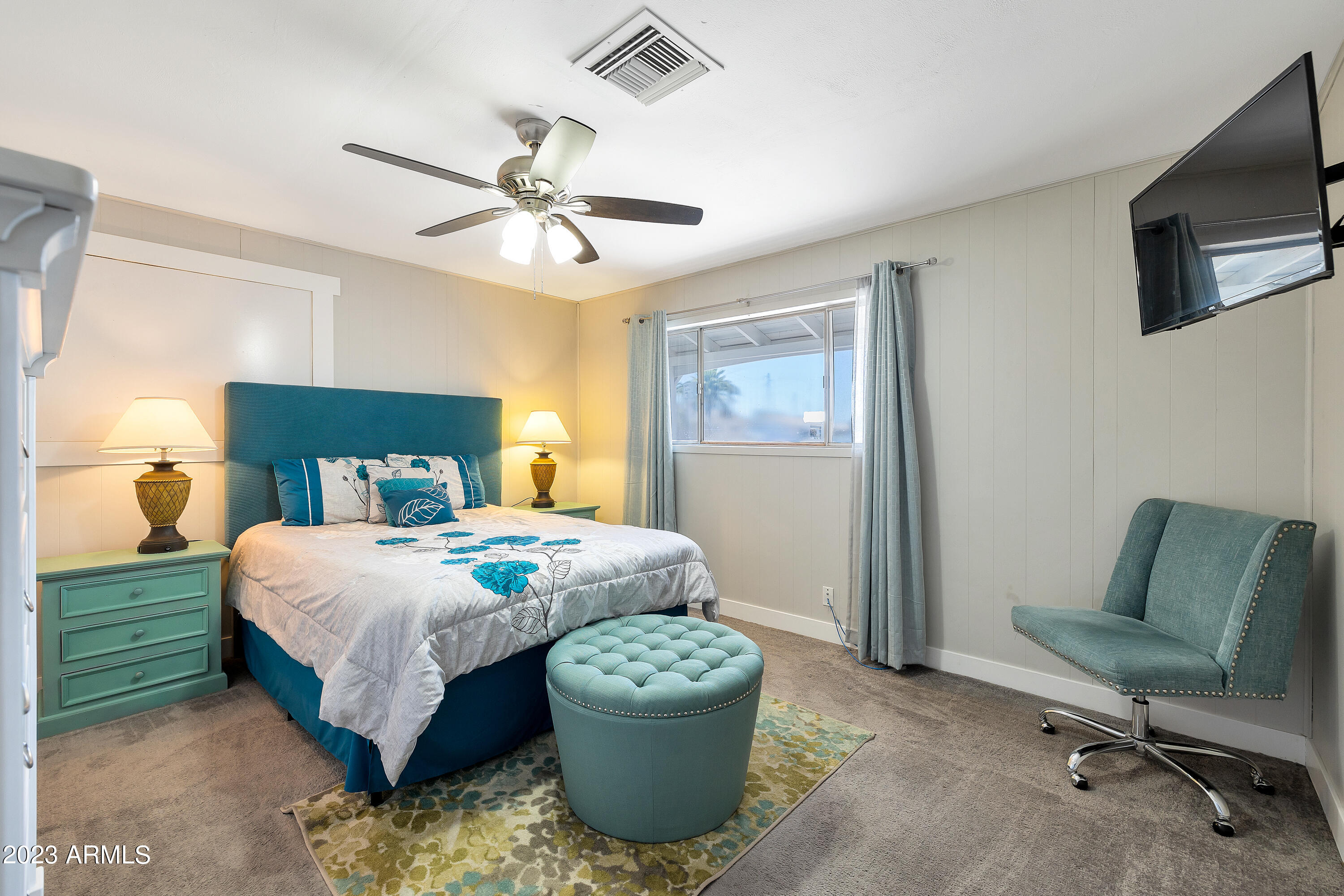 5473 West Osborn Road Phoenix, AZ 85031 - Photo 13 of 37 a bedroom with a bed and a chandelier