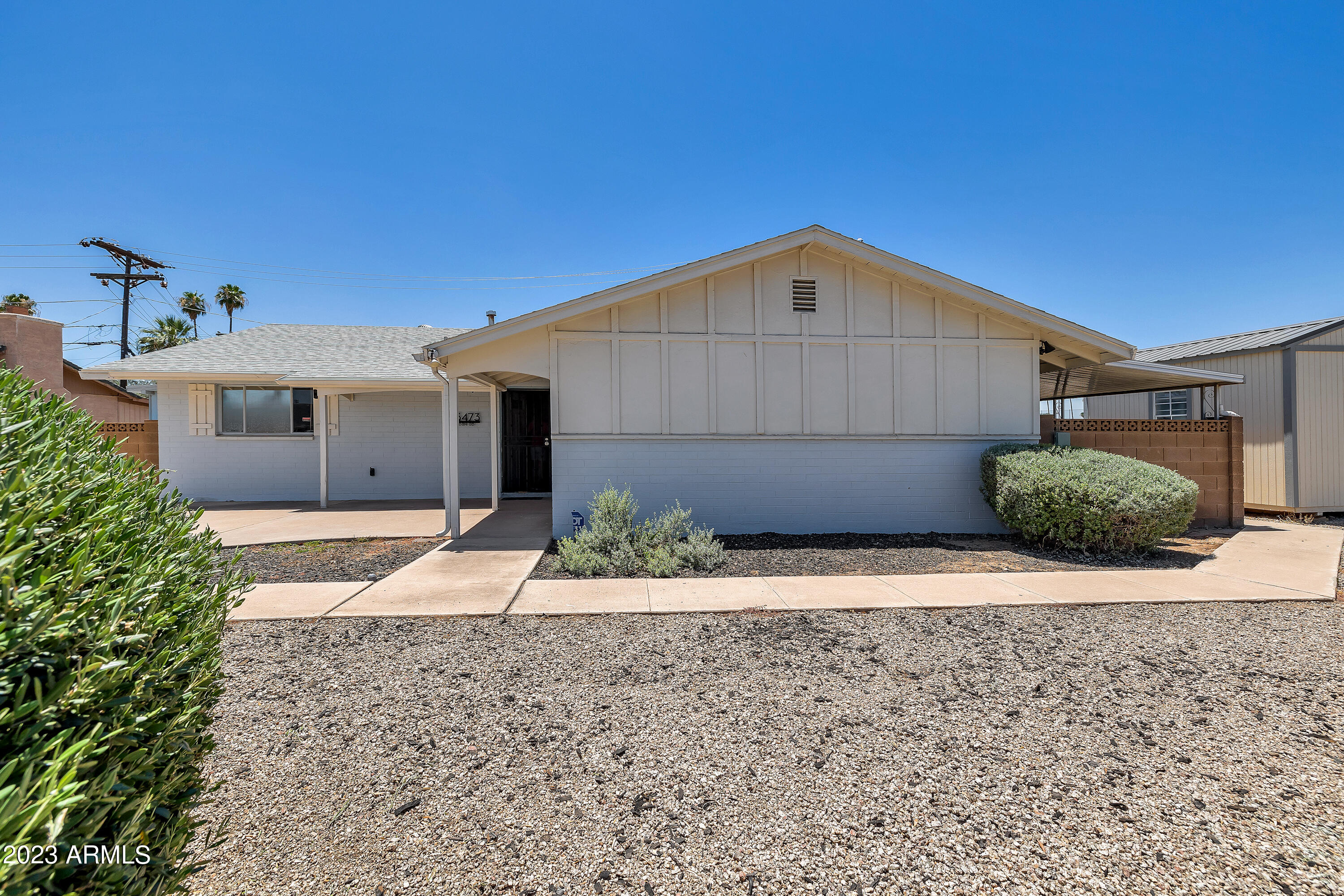 5473 West Osborn Road Phoenix, AZ 85031 - Photo 2 of 37 a front view of a house with a yard and garage