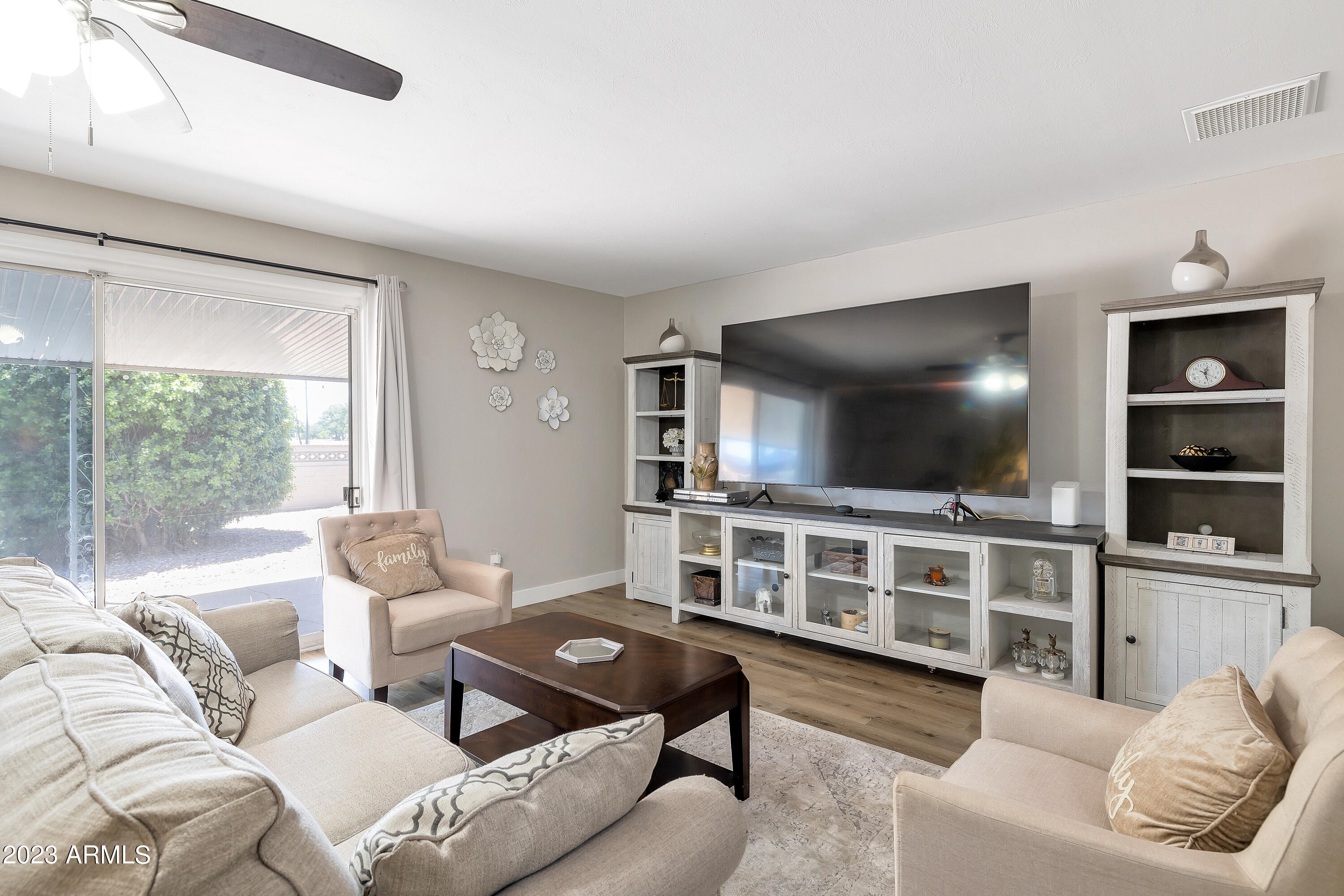 5473 West Osborn Road Phoenix, AZ 85031 - Photo 21 of 37 a living room with furniture and a flat screen tv