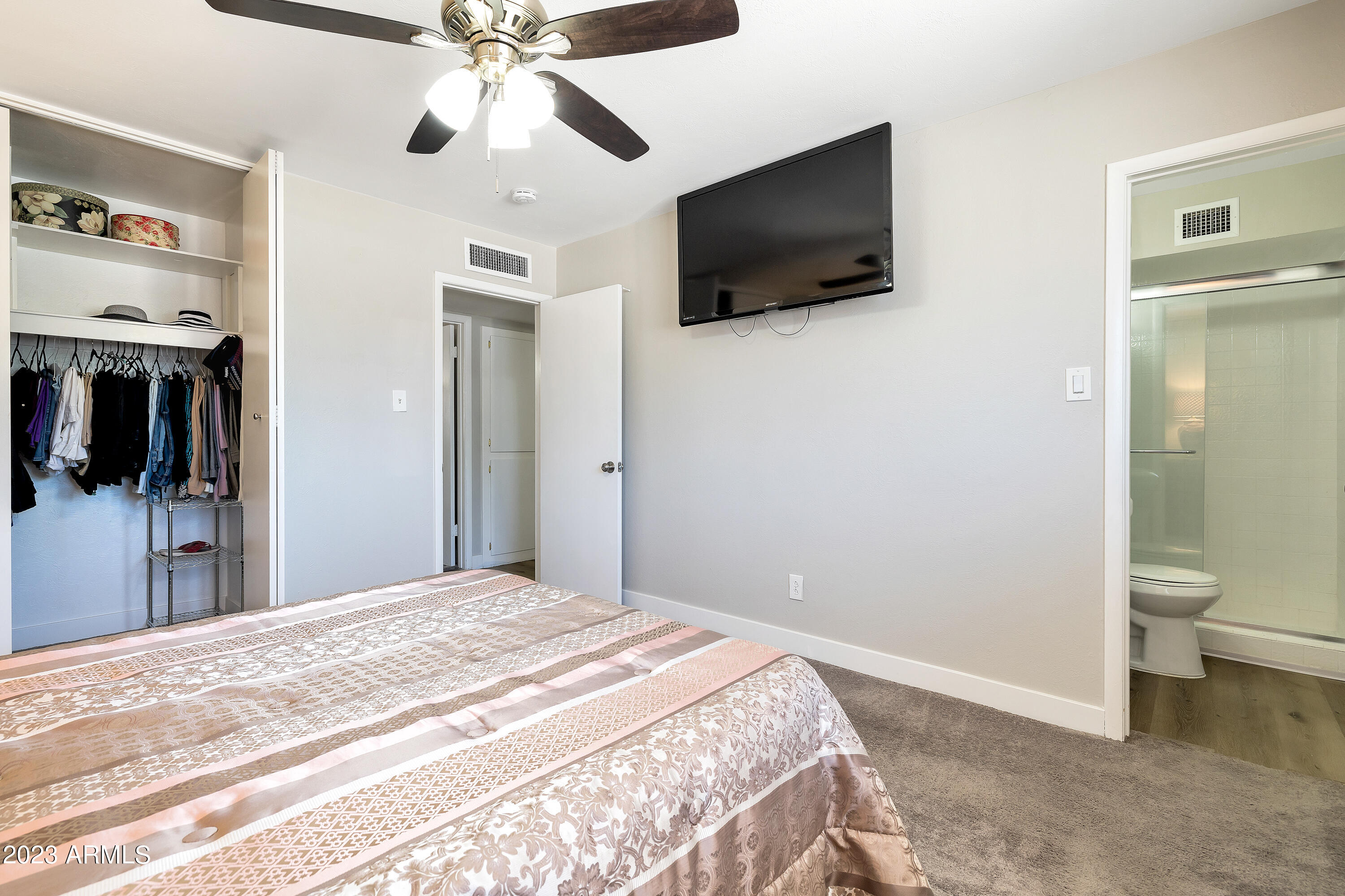 5473 West Osborn Road Phoenix, AZ 85031 - Photo 27 of 37 a bedroom with a bed and a flat screen tv