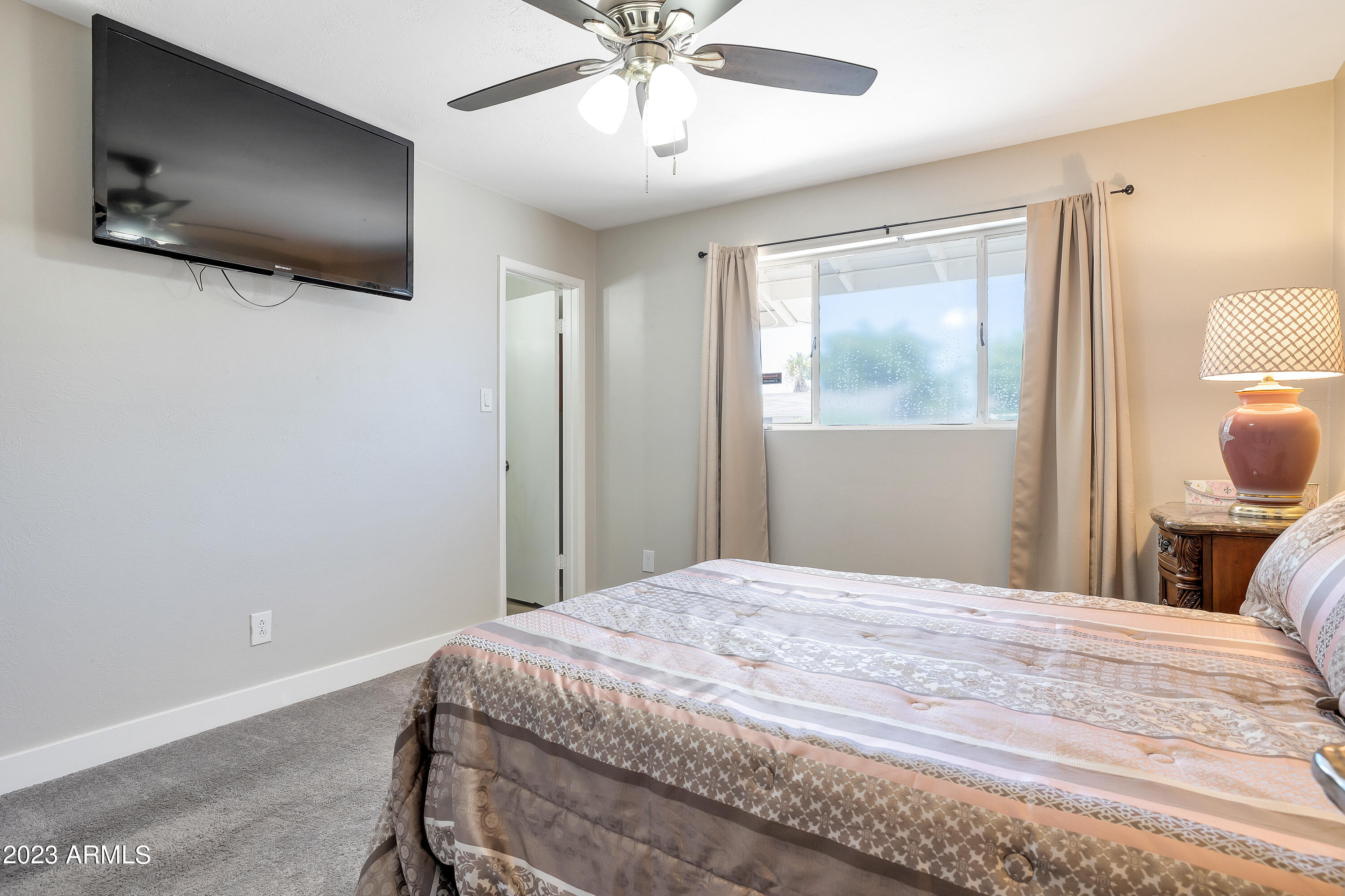 5473 West Osborn Road Phoenix, AZ 85031 - Photo 28 of 37 a bedroom with a bed and a flat screen tv
