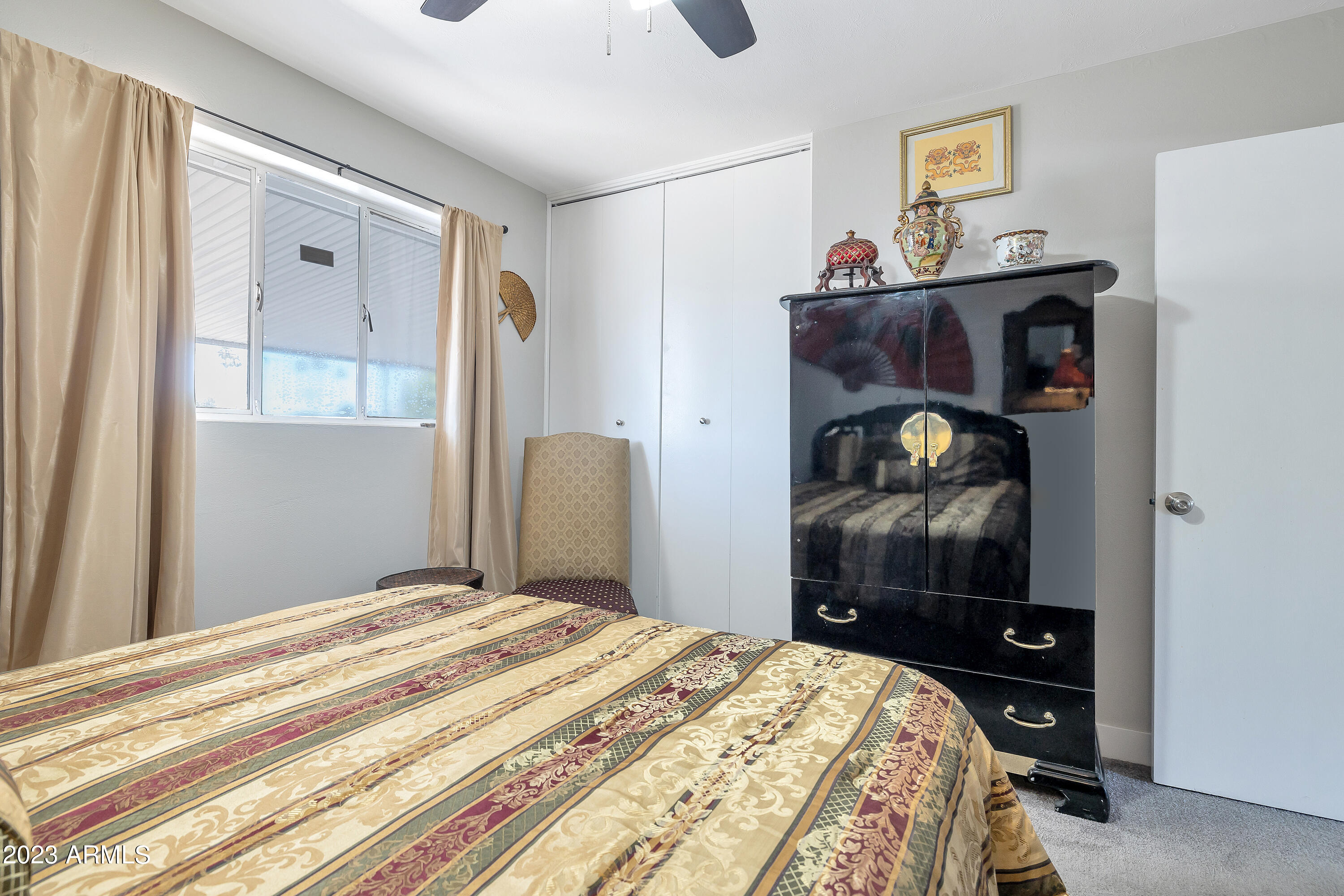 5473 West Osborn Road Phoenix, AZ 85031 - Photo 30 of 37 a bedroom with a bed and a dresser