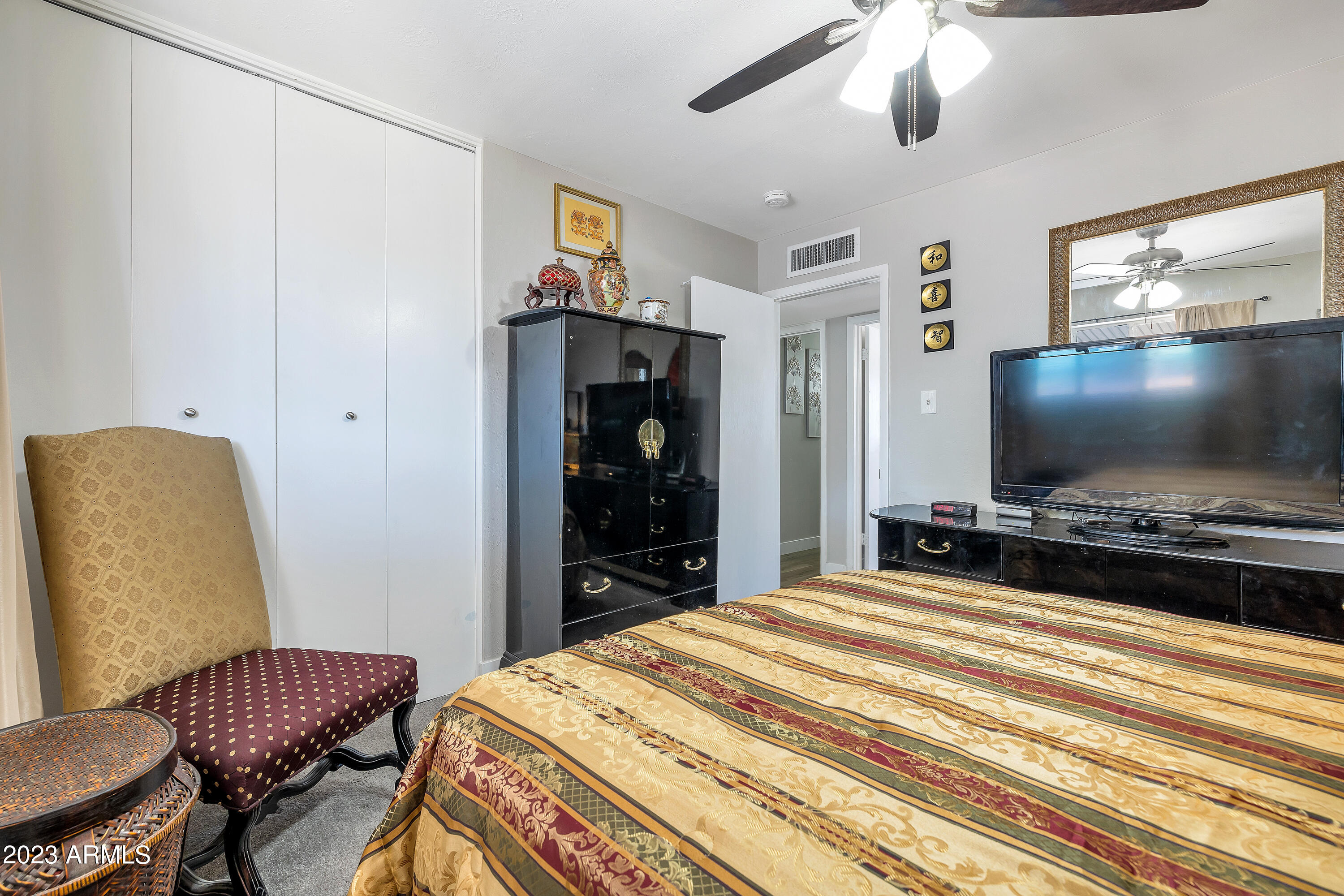 5473 West Osborn Road Phoenix, AZ 85031 - Photo 32 of 37 a bedroom with a bed and a flat screen tv