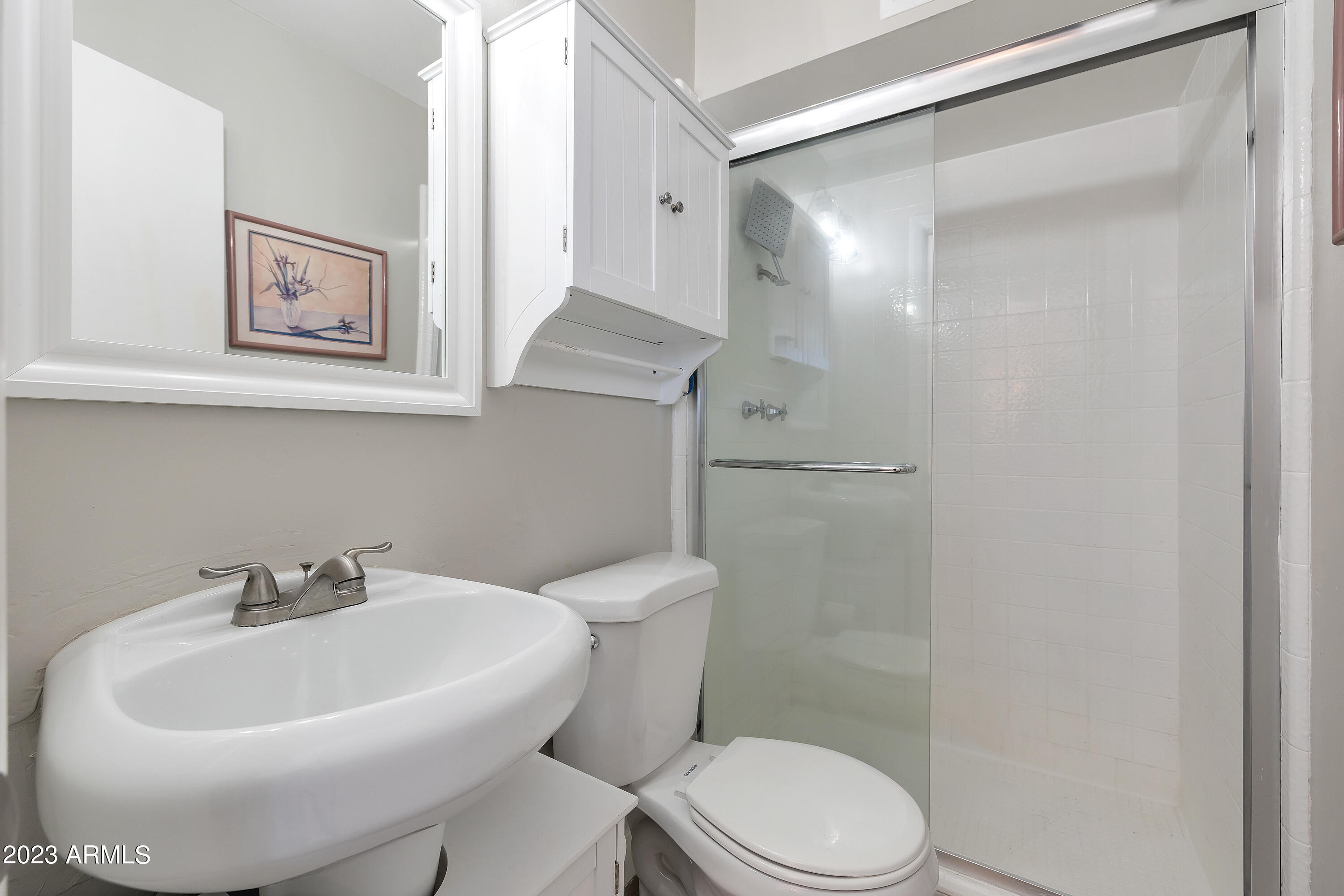 5473 West Osborn Road Phoenix, AZ 85031 - Photo 33 of 37 a white toilet sitting next to a bathroom sink